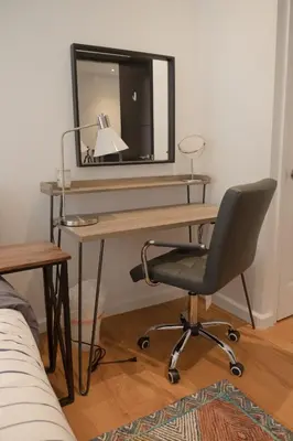 a desk with a chair and a mirror at 3 BD next to Central Park in New York