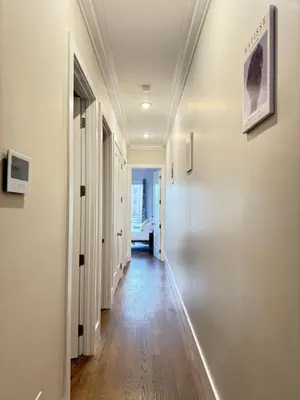 an empty hallway with white walls and wooden floors at NYC Gateway, 30minutes from Manhattan in Jersey City