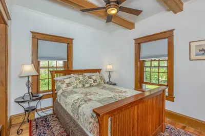 a bedroom with a bed and a ceiling fan at Rose & Thorne in Gardiner