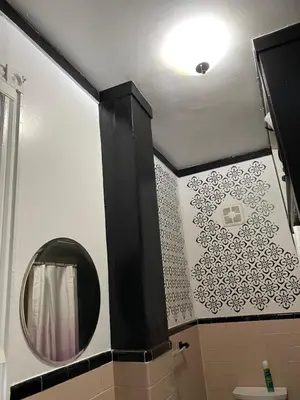 a bathroom with a mirror and a white wall at Scenic easy go to TIMES SQUARE in North Bergen