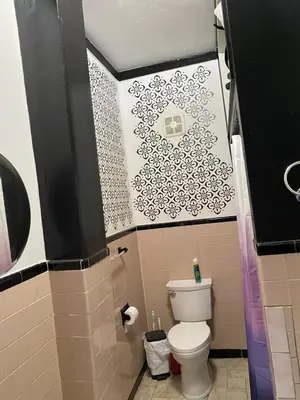 a bathroom with a white toilet in a room at Scenic easy go to TIMES SQUARE in North Bergen