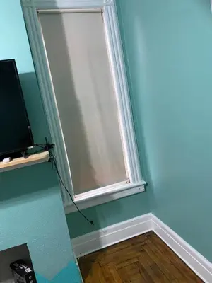 a window in the corner of a room with a television at Scenic easy go to TIMES SQUARE in North Bergen