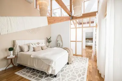 a bedroom with a white bed and a large window at Light filled zen 3BR Penthouse - 7 min to Westport in Weston
