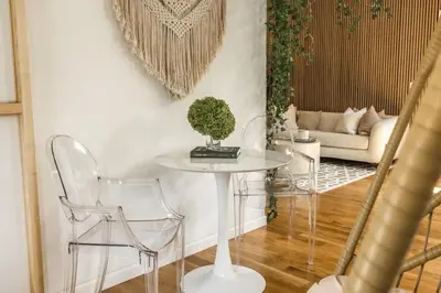 a living room with a table and chairs and a couch at Light filled zen 3BR Penthouse - 7 min to Westport in Weston