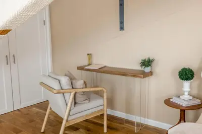 a room with a chair and a shelf on the wall at Light filled zen 3BR Penthouse - 7 min to Westport in Weston