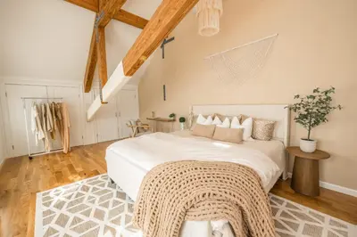 a bedroom with a large white bed and wooden floors at Light filled zen 3BR Penthouse - 7 min to Westport in Weston