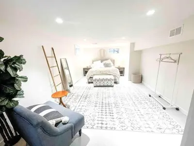 a living room with a bed and a blue couch at Modern Westport Studio with Pool Table & Lounge in Westport