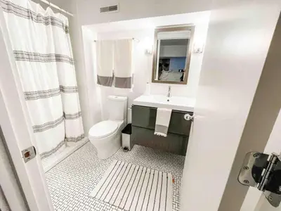 a bathroom with a toilet and a sink and a mirror at Modern Westport Studio with Pool Table & Lounge in Westport