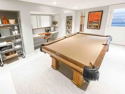 a pool table in a living room with at Modern Westport Studio with Pool Table & Lounge in Westport