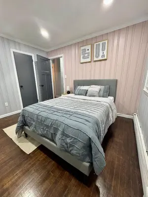 a bedroom with a large bed with pink walls at Vernon Cozy 2BD Pet-Friendly Mountain Creek in Vernon