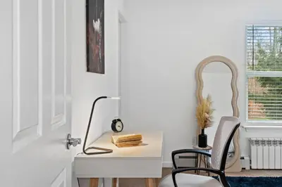 a white desk with a chair and a mirror at Enchanted Villa in Pocono Summit