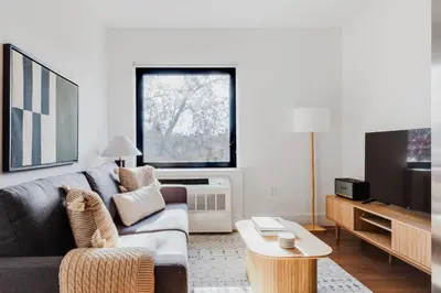 a living room with a couch and a tv at Blueground Clinton Hill gym AC nr park NYC-1674 in Brooklyn
