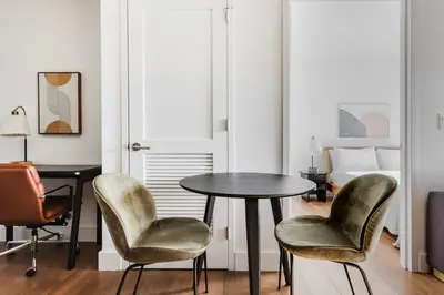 a room with a table and two chairs and a bed at Blueground Clinton Hill gym AC nr park NYC-1674 in Brooklyn