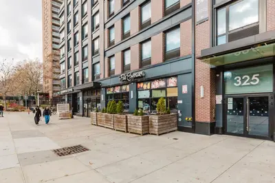 a street with a store on the side of a building at Blueground Clinton Hill gym AC nr park NYC-1674 in Brooklyn