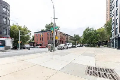 an empty street in a city with cars parked at Blueground Clinton Hill gym AC nr park NYC-1674 in Brooklyn