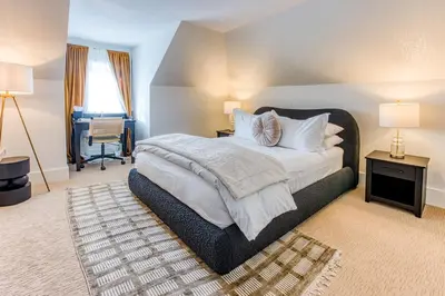 a bedroom with a large bed and a desk at Doctor Sax House in Lenox