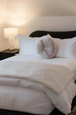a white bed with a pillow on top of it at Doctor Sax House in Lenox