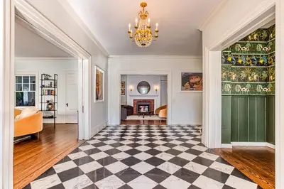 a living room with a checkered floor and a chandelier at Doctor Sax House in Lenox