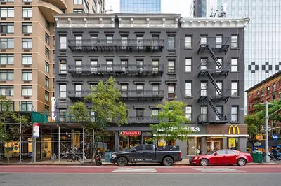 a black truck parked in front of a building at 1290-10 New Renovated 2 Bedrooms in UES in New York