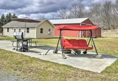a swing set with a table and an umbrella at Clydesdale Cottage by Equestrian House in Pleasant Mount