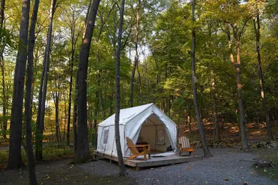 a white tent in the middle of a forest at Heavens Landing at Moon Valley Campground in Vernon Township