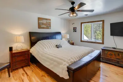 a bedroom with a bed and a flat screen tv at 3 Mi to Colgate Lake Mtn-View Home, Deck and Grill! in East Jewett