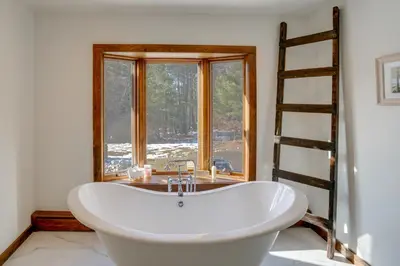 a bath tub in a bathroom with a window at 3 Mi to Colgate Lake Mtn-View Home, Deck and Grill! in East Jewett