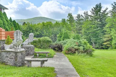 a park with two statues and two benches at 3 Mi to Colgate Lake Mtn-View Home, Deck and Grill! in East Jewett