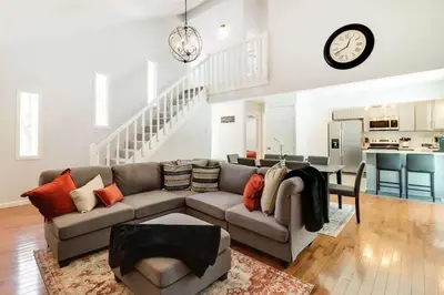 a living room with a couch and a clock on the wall at Family fun at Casa Ledges in Tobyhanna