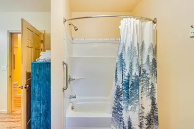 a bathroom with a shower with a blue and white shower curtain at Near Historic Sites Bright Hyde Park Guest Suite in Hyde Park