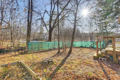 a park with a fence and trees and the sun at Near Historic Sites Bright Hyde Park Guest Suite in Hyde Park