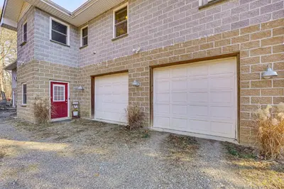 a brick house with two garage doors on it at Near Historic Sites Bright Hyde Park Guest Suite in Hyde Park