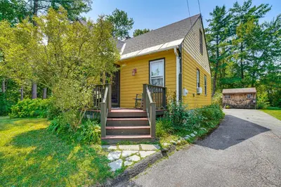 a yellow house with stairs leading to the front door at 1 Mi to Dtwn Beautiful Home in Williamstown! in Williamstown
