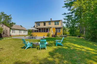 a yard with a table and chairs in front of a house at 1 Mi to Dtwn Beautiful Home in Williamstown! in Williamstown