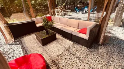 a couch sitting on top of a gravel patio at 5 Bedroom Cozy Retreat Lakefront in Mount Zion