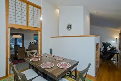 a dining room with a wooden table and chairs at Amherst Woodland Escape in Amherst