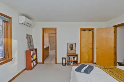 a bedroom with a bed and a book shelf at Amherst Woodland Escape in Amherst