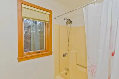 a bathroom with a shower and a window at Amherst Woodland Escape in Amherst
