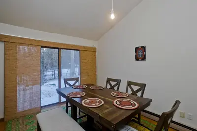 a dining room with a wooden table and chairs at Amherst Woodland Escape in Amherst