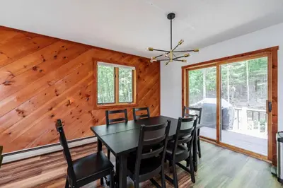 a dining room with a table and chairs at Cozy Villager Chalet w Mountain Views and Firepit in Dover