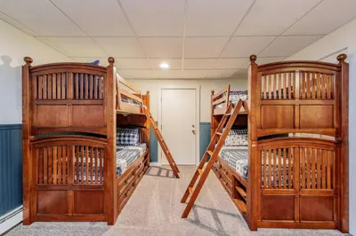 two bunk beds are in a room with at Cozy Villager Chalet w Mountain Views and Firepit in Dover
