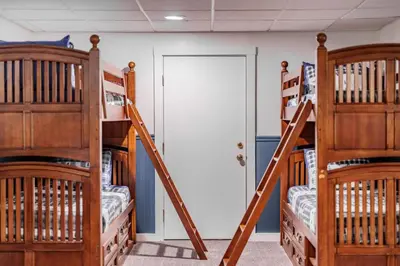 a room with three bunk beds and a door at Cozy Villager Chalet w Mountain Views and Firepit in Dover