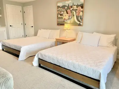 two beds sitting in a room with at Mount Snow Best View - Sauna - HotTub - Pool - Fireplace in West Dover