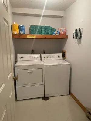 a white washing machine in a room with a shelf at Mount Snow Best View - Sauna - HotTub - Pool - Fireplace in West Dover