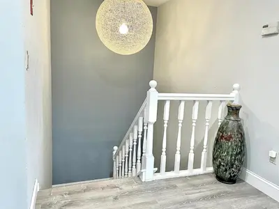 a vase sitting on the floor next to a staircase at Mount Snow Best View - Sauna - HotTub - Pool - Fireplace in West Dover