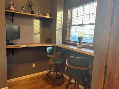 a home bar with two chairs and a television at NEW Modern Private Entrance 2 BD Apt Minutes to NYC in Jersey City
