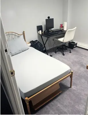 a bedroom with a bed and a desk with a computer at Comfy Room in Fresh Meadows in Utopia