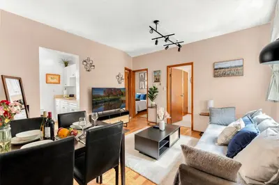 a living room with a couch and a table at Stylish 2 Bedroom Apartment in Chelsea in New York