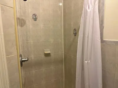 a bathroom with a shower with a shower curtain at Great! Private NYC Room in Sunnyside in Haberman