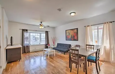 a living room with a table and a couch at Great! Private NYC Room in Sunnyside in Haberman